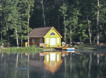 Front of cabin with hot tub in summer